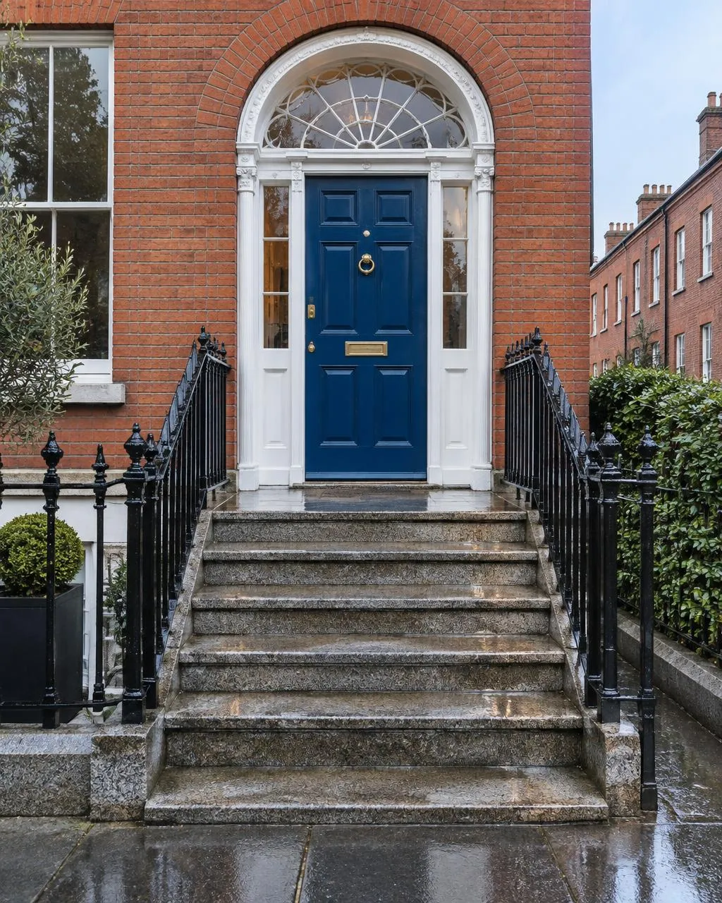 Clean granite steps and railings of a Dublin red-brick home